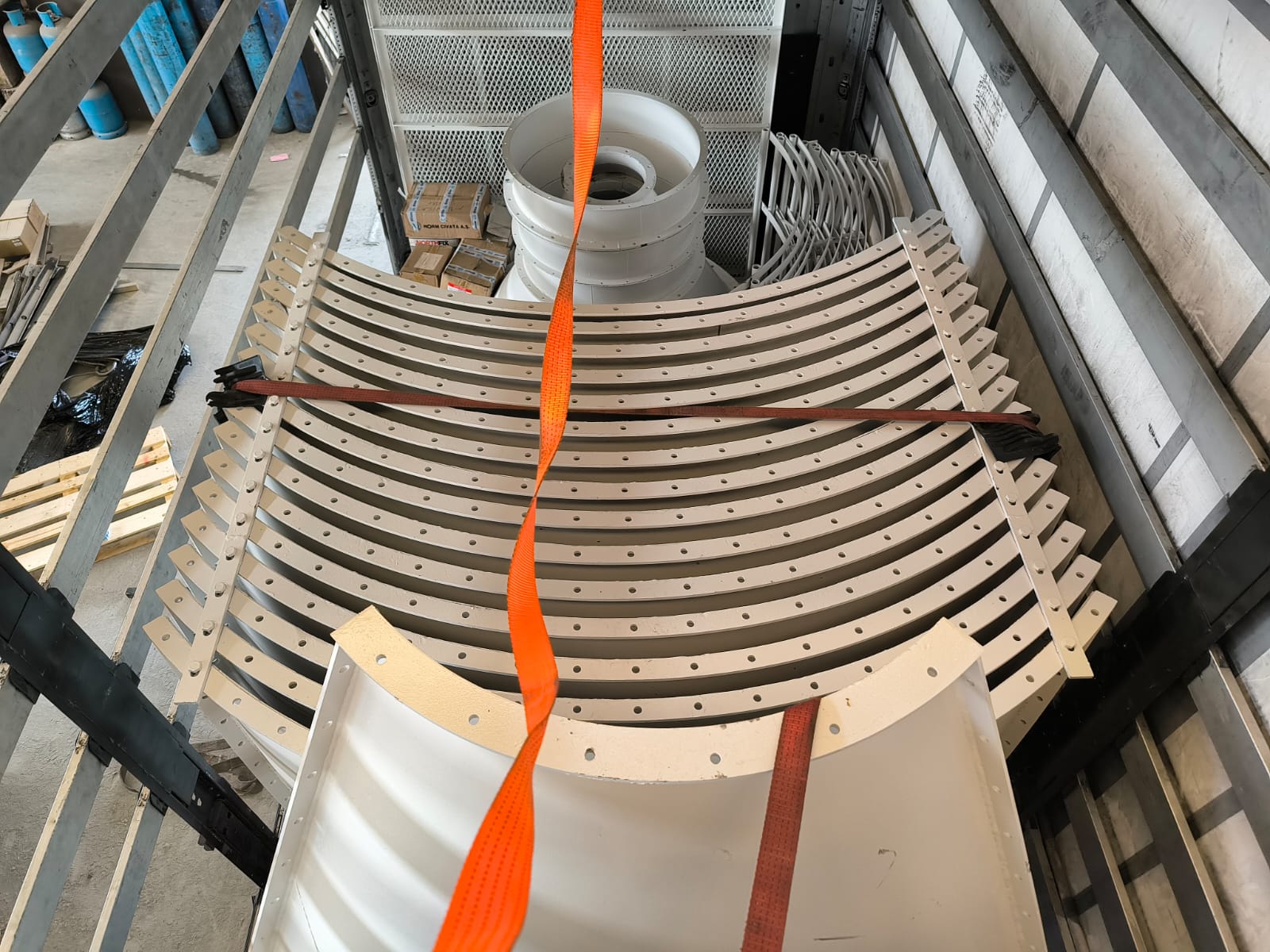 Curved bolted silo panels stacked for transport